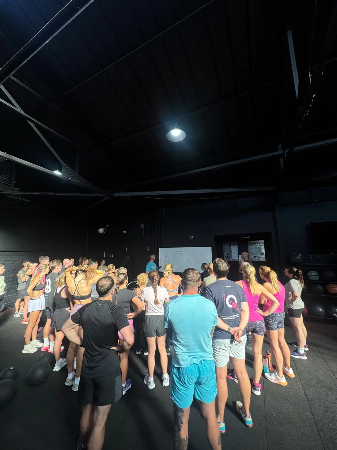 Members gathered round a coach before a class at Commando X-Fit