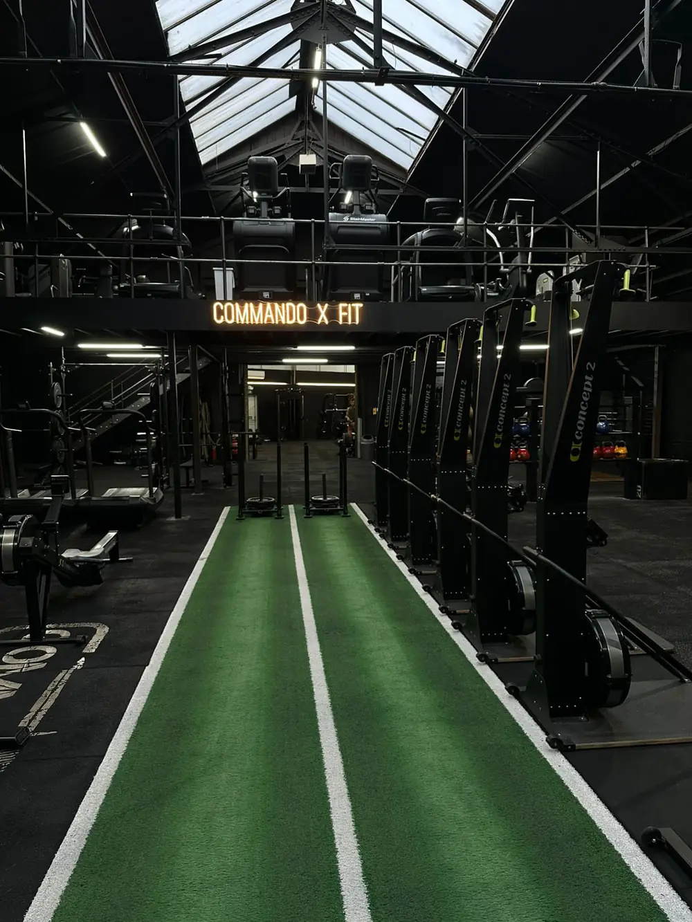 The turf sled track running down the middle of the gym