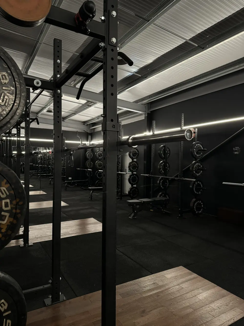 A row of squat racks and platforms at Commando X-Fit