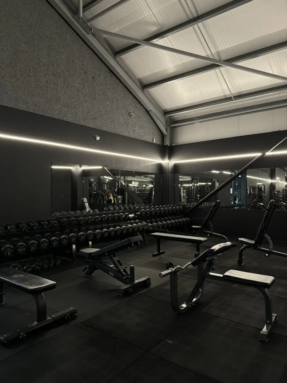 The strength room at Commando X-Fit, with benches and free weights