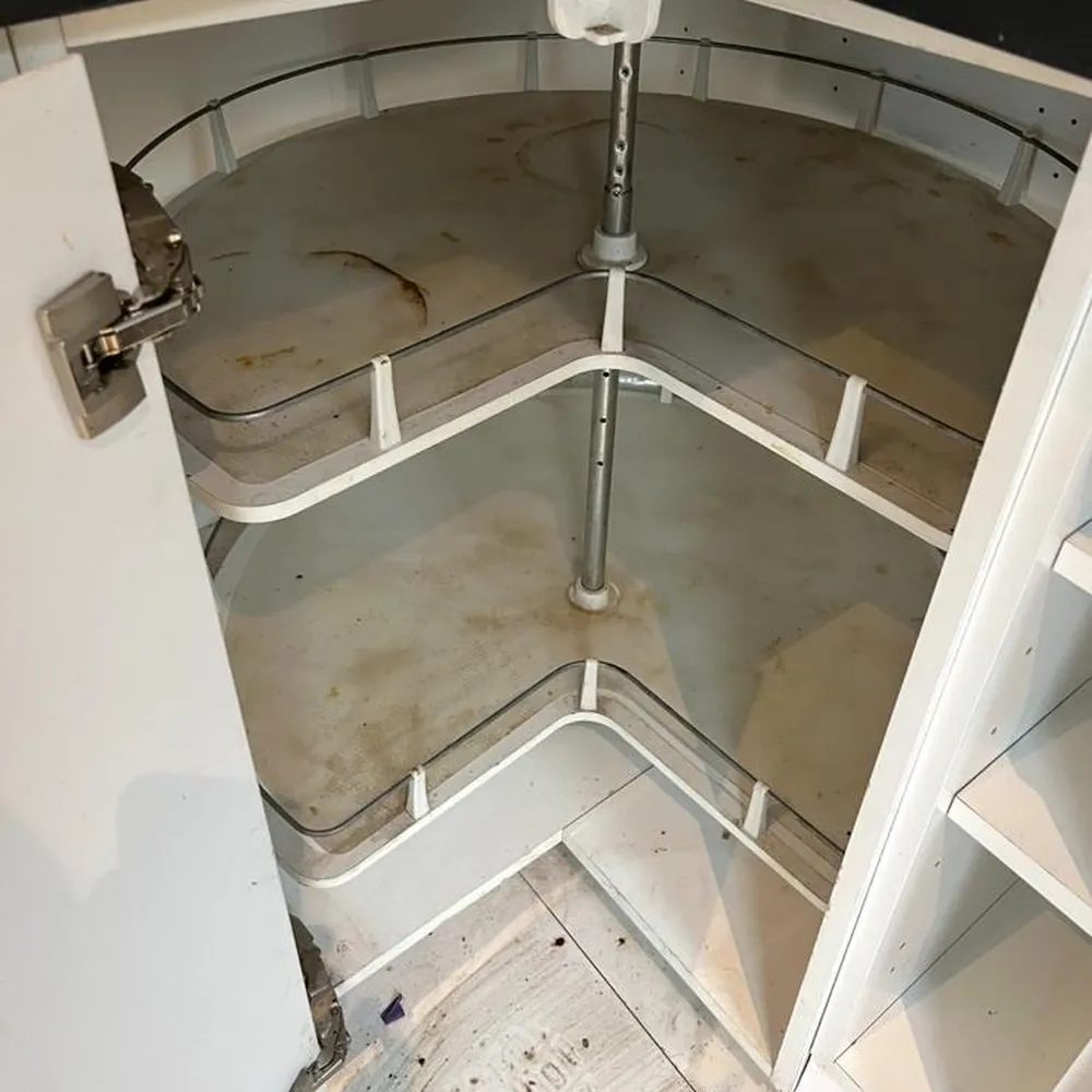 Inside of a kitchen corner unit, dirty before cleaning
