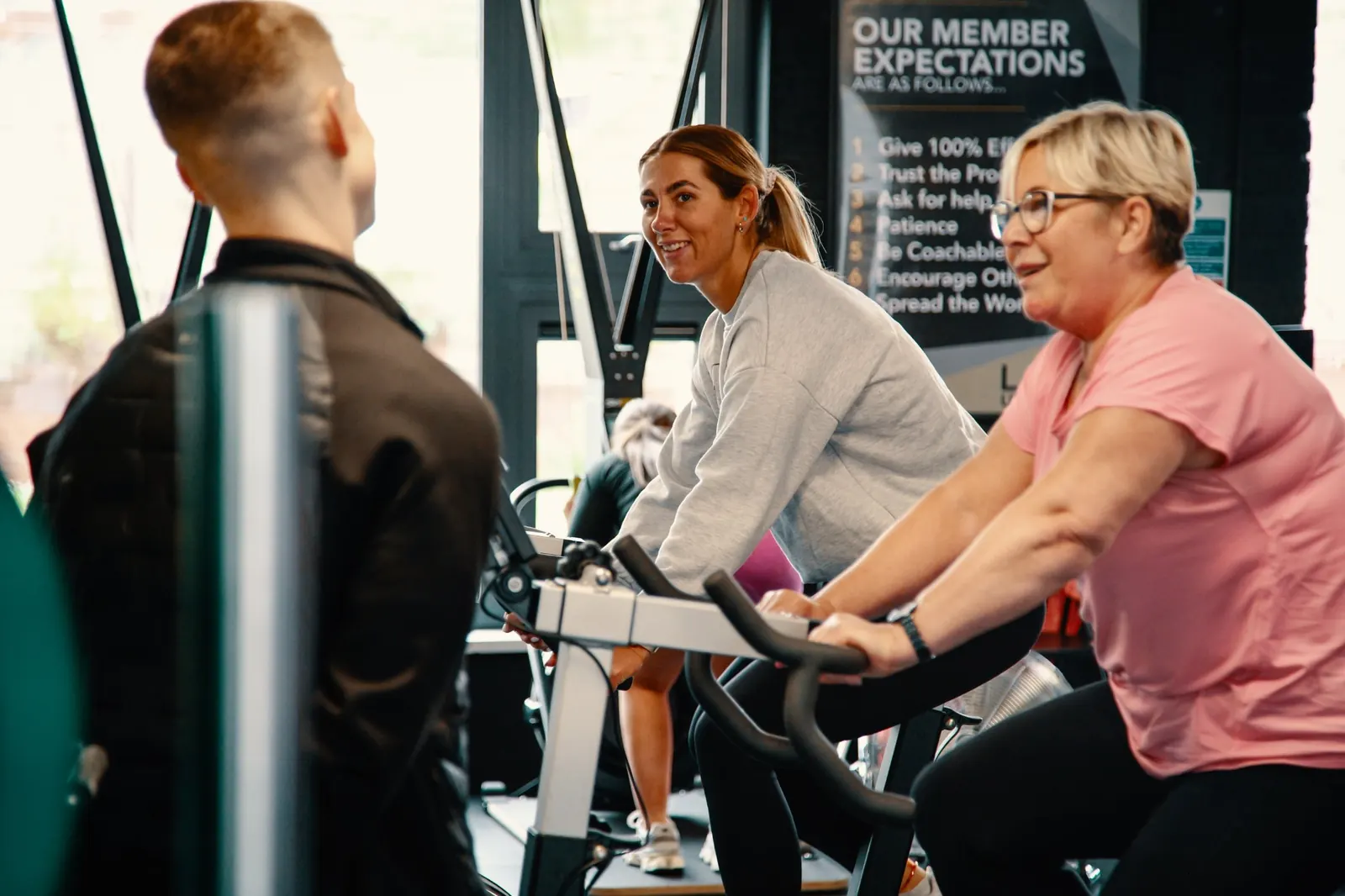 Members chatting and laughing on the bikes at Level Up Fitness in North Belfast