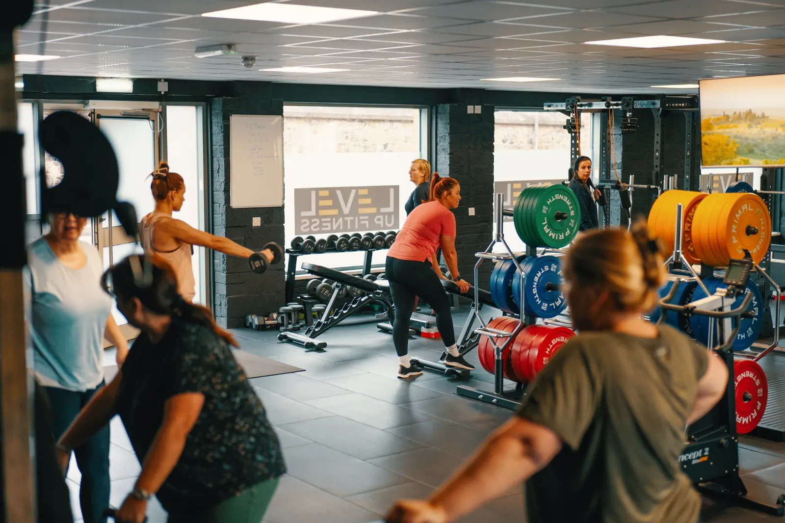 A small group session at Level Up Fitness, with each member working at a different station
