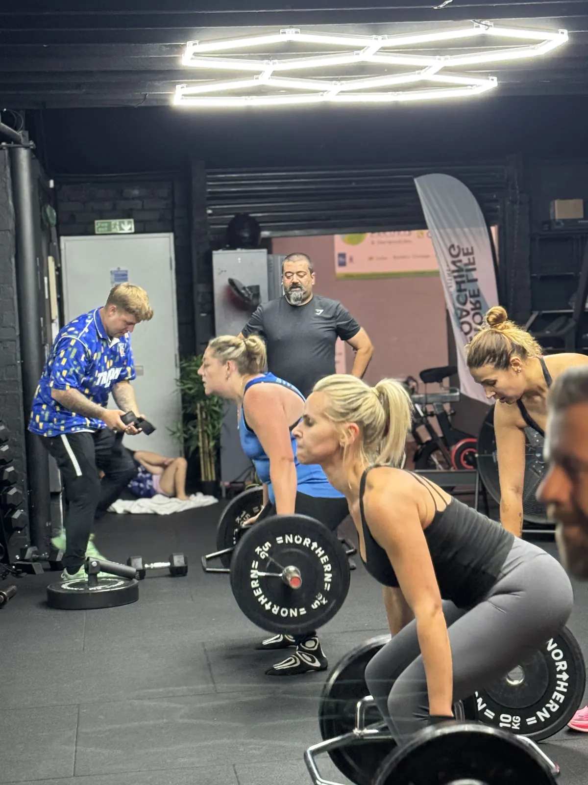 A small group of members lifting barbells together at More Life Coaching in Sutton Coldfield