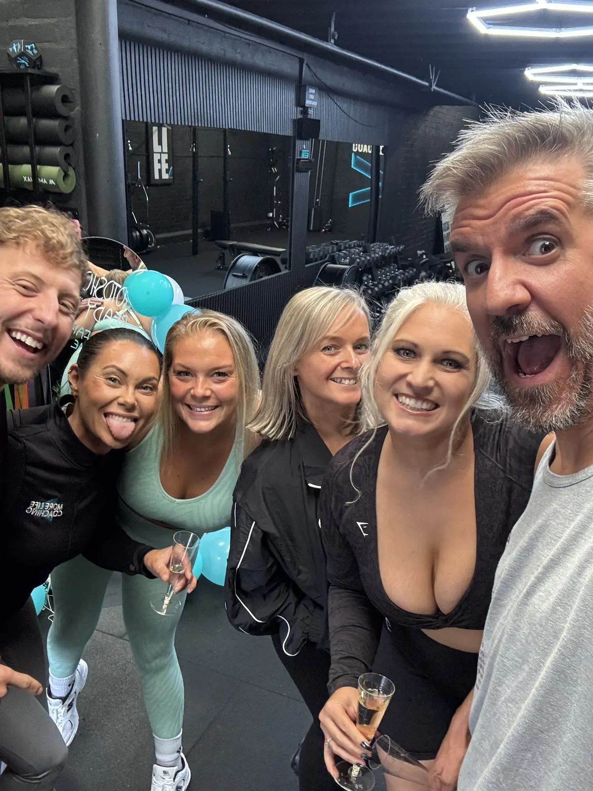 More Life Coaching members and coaches taking a selfie together at a social in the studio