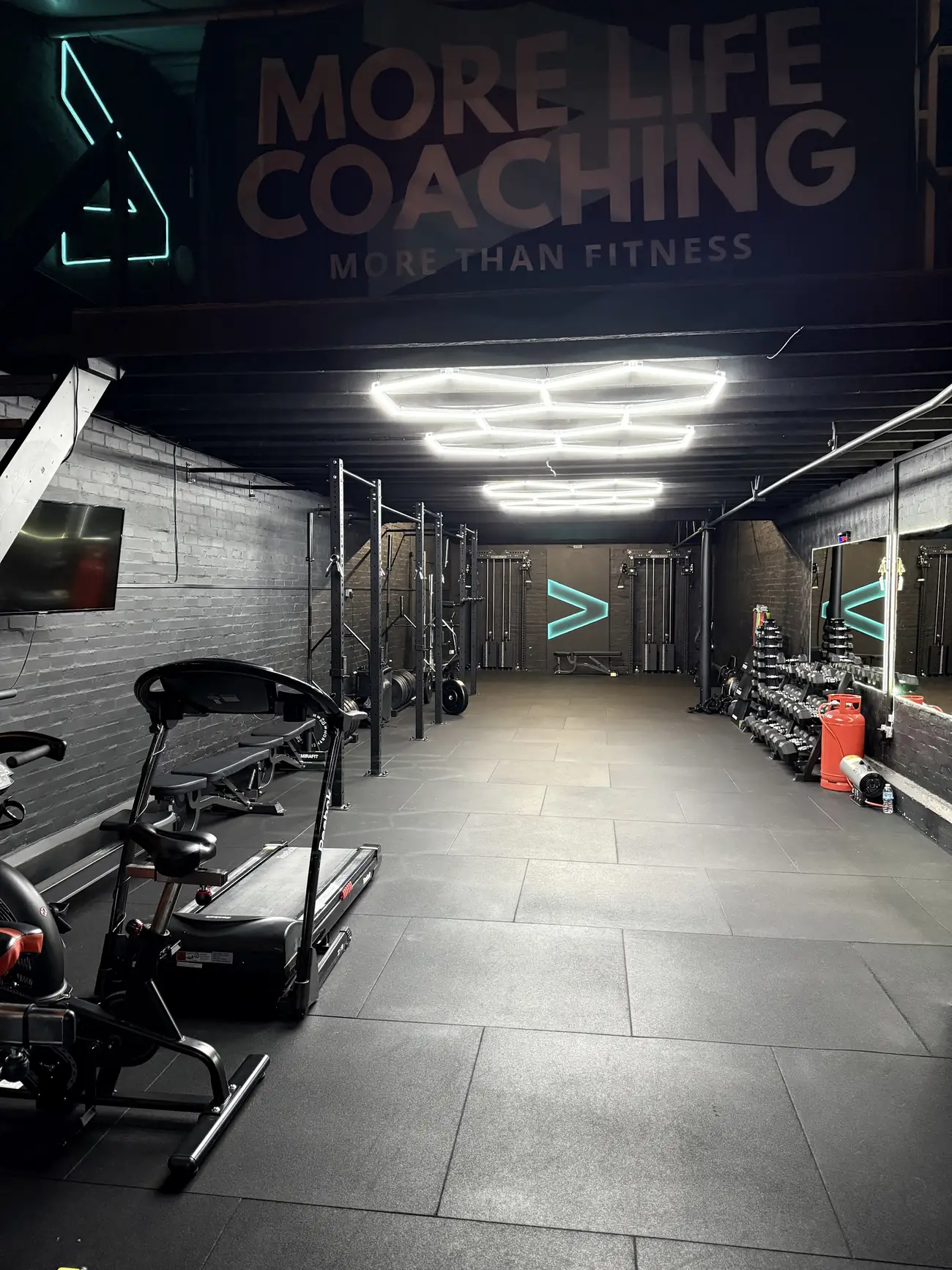 The More Life Coaching studio in Sutton Coldfield: black walls, squat racks and white hexagon lights on the ceiling